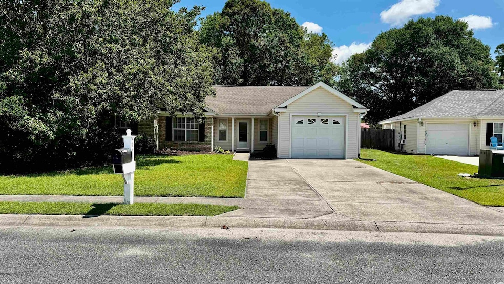 Single story home with concrete driveway, an attached garage, and roof with shingles