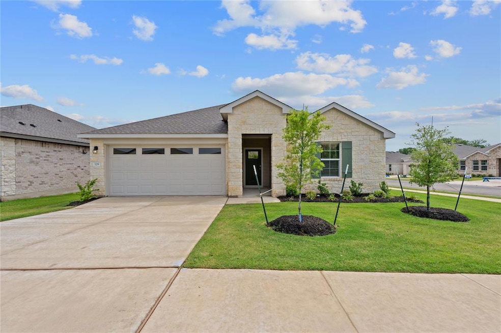Ranch-style house featuring concrete driveway, an