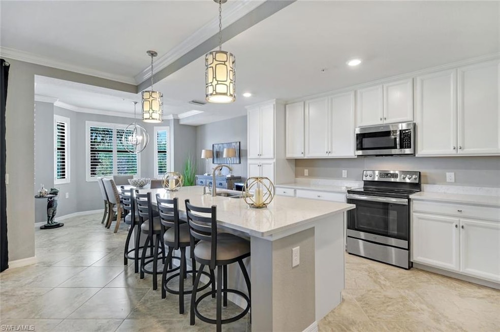 Kitchen with quartz countertops, stainless steel appliances, Pendant lighting, and custom cabinetry.