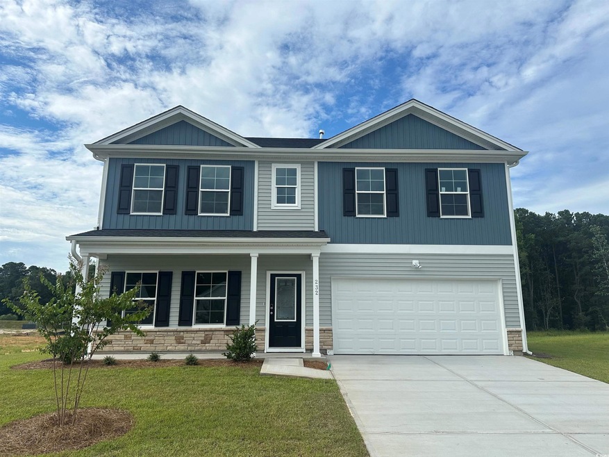 View of front facade with a garage and a front law
