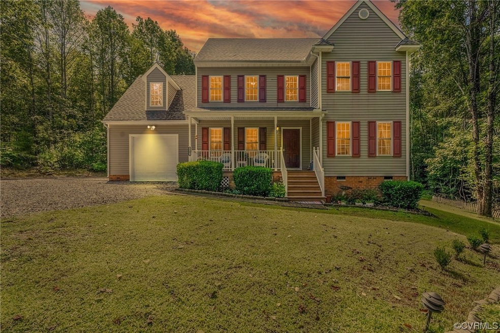 Colonial-style house featuring a yard, a garage, a