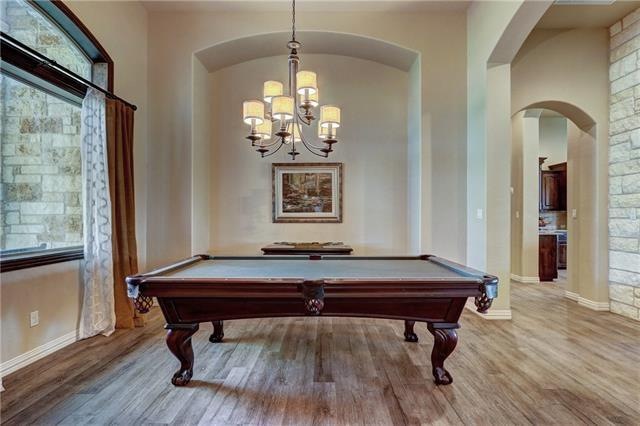 Formal dining room with hard tile floors that look like real wood.