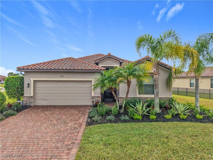 Mediterranean / spanish house with a front lawn, f
