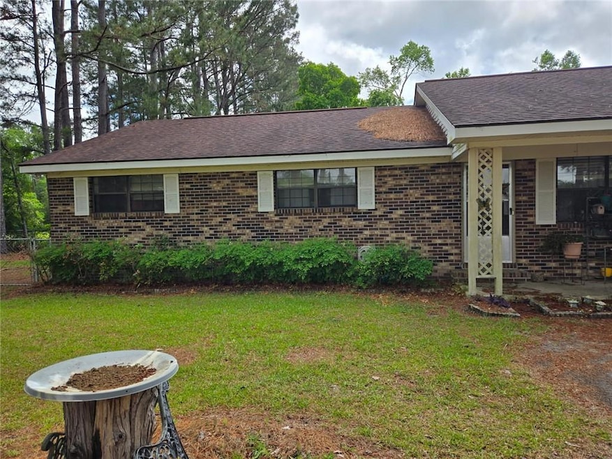 View of front of home featuring brick siding and a