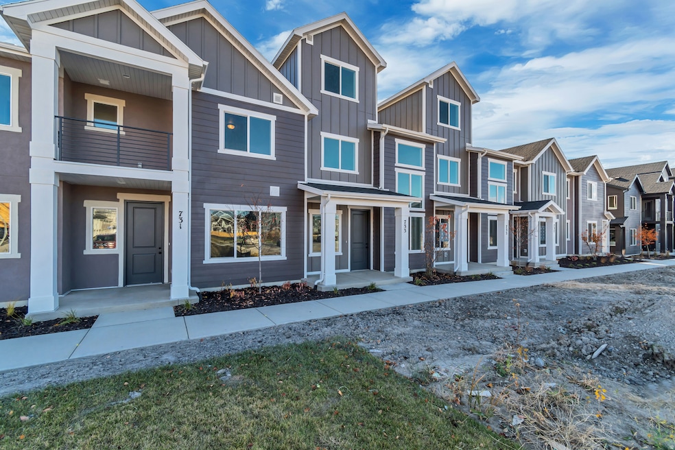 View of front facade with a residential view, board and batten siding, and a balcony