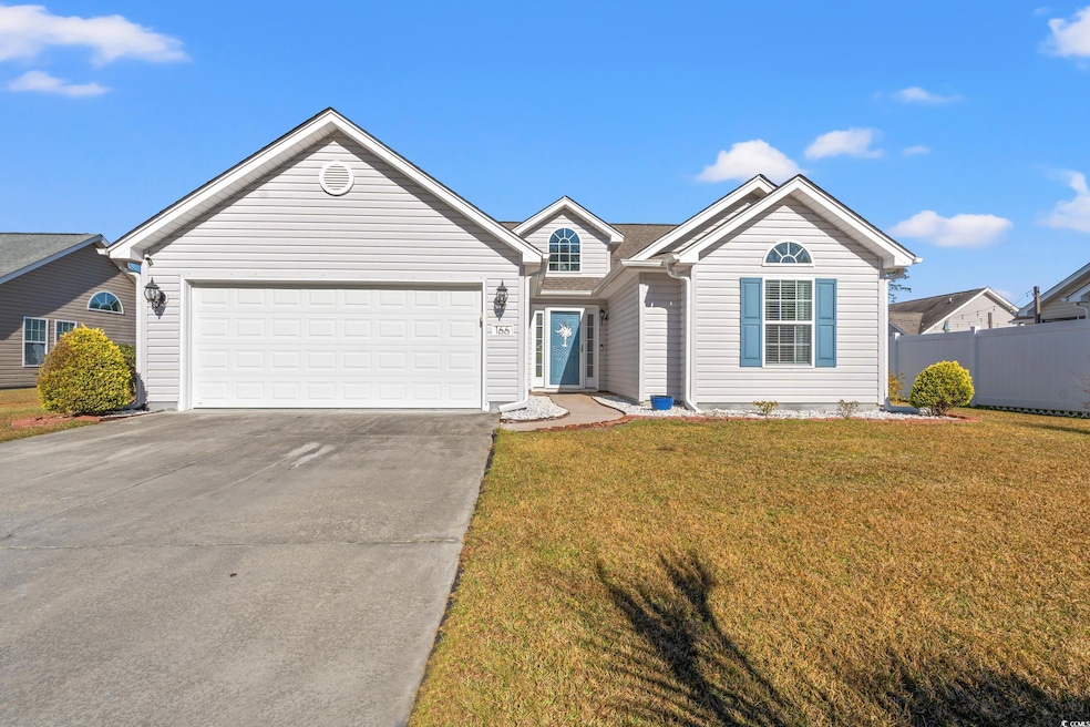 Ranch-style house with a front yard and a garage