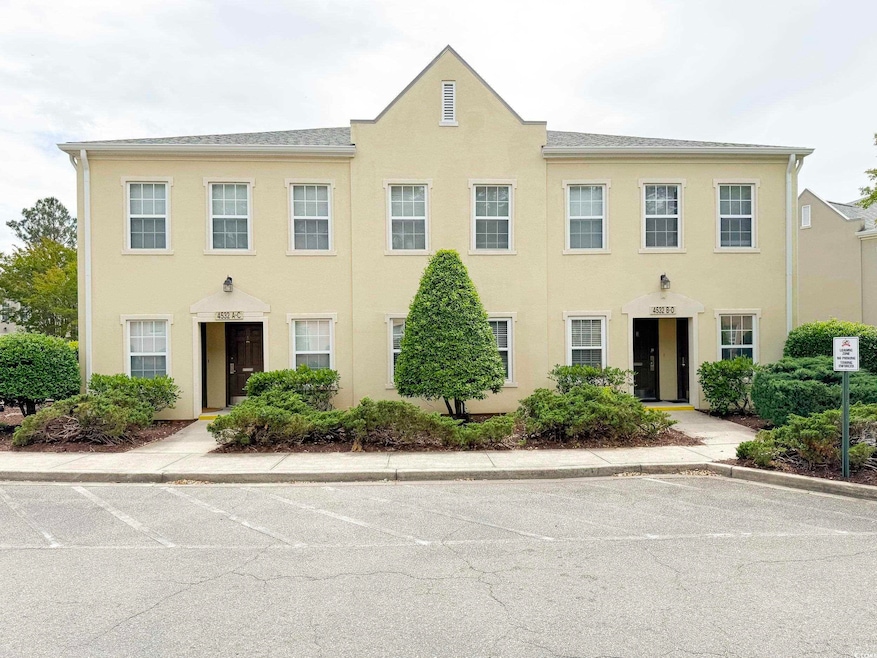 View of property with uncovered parking