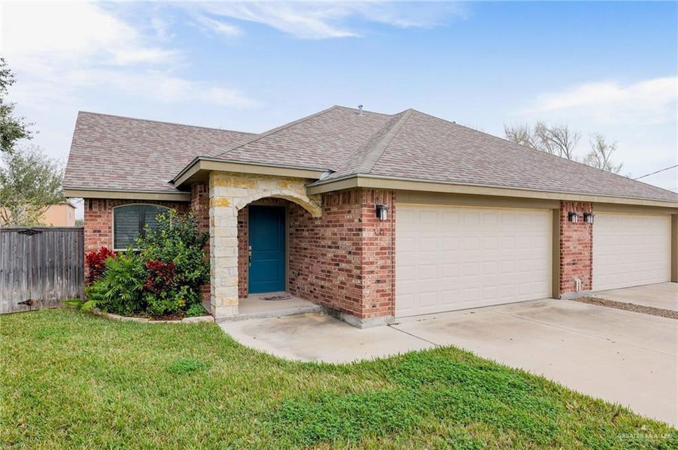 View of front of house featuring roof with shingles, brick siding, driveway, and an attached garage