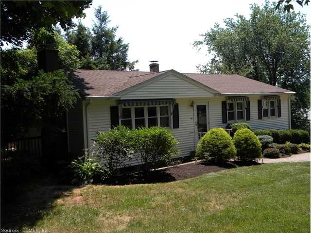 Exterior Front. Long Ranch w/ Canvas awnings.