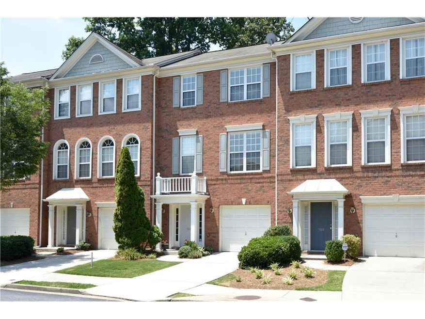 Front of town home with covered porch and brick fr
