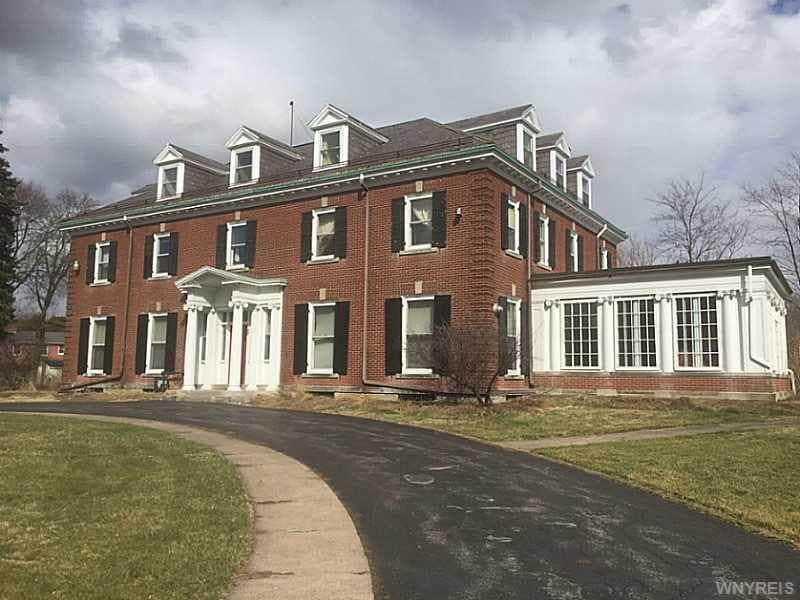 Exterior Front. South wing of the house is a Solar