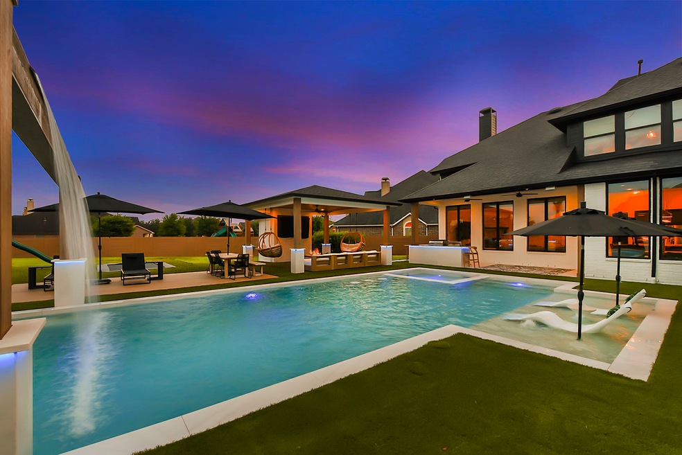 2523 Haven Hill offers a backyard that rivals a resort, featuring a heated square pool and spa complete with beach chair seating for ultimate relaxation. Surrounding the pool and entertainment area is synthetic grass, providing a lush and low-maintenance landscape. A pergola provides ample seating and space for entertaining guests, while a full bathroom with a stand-up shower ensures convenience and comfort. Additionally, a covered patio equipped with a full kitchen and bar seating.