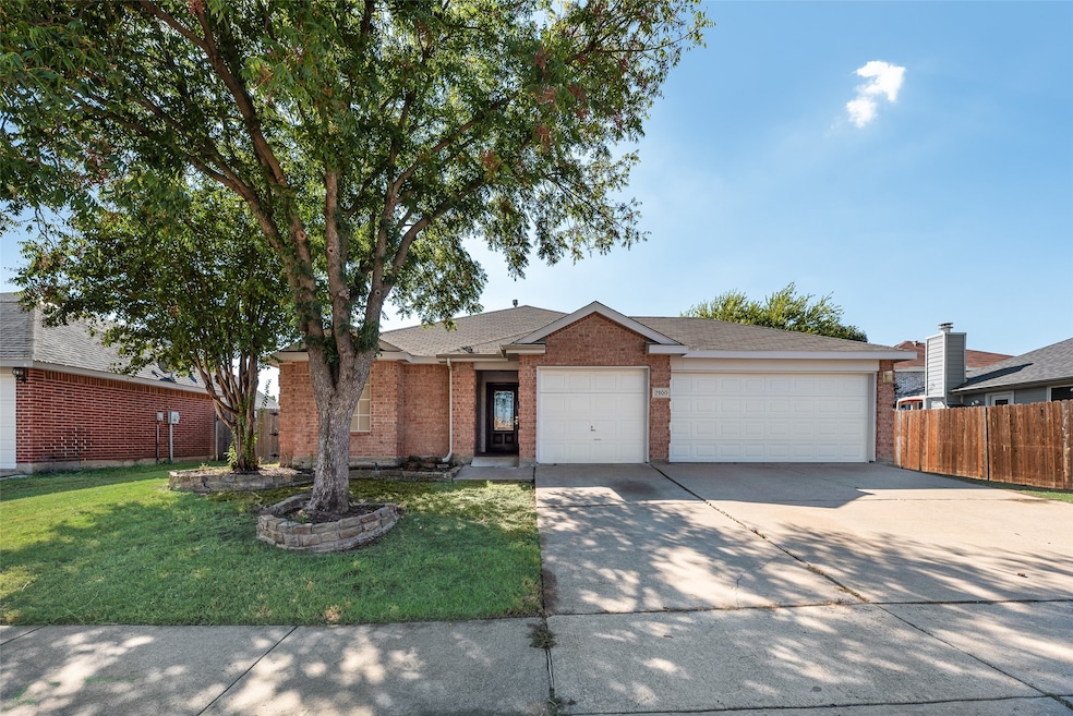 Single story home with driveway, brick siding, a garage, and roof with shingles