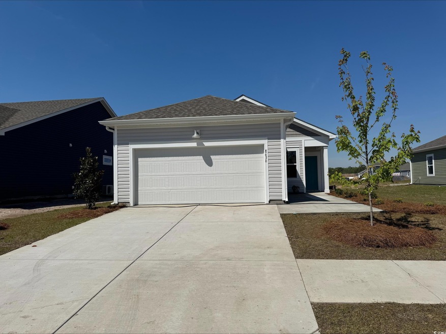 Ranch-style home with driveway and a garage