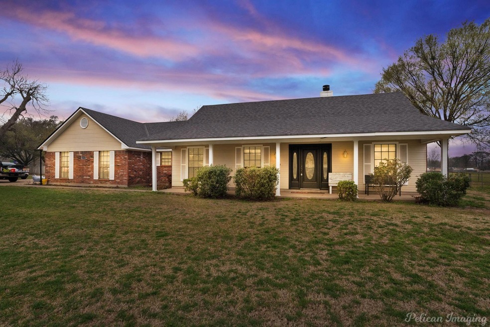 Single story home with a porch, a chimney, a front