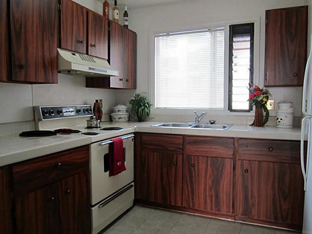 A cozy kitchen  has lots of cabinets and is ideal