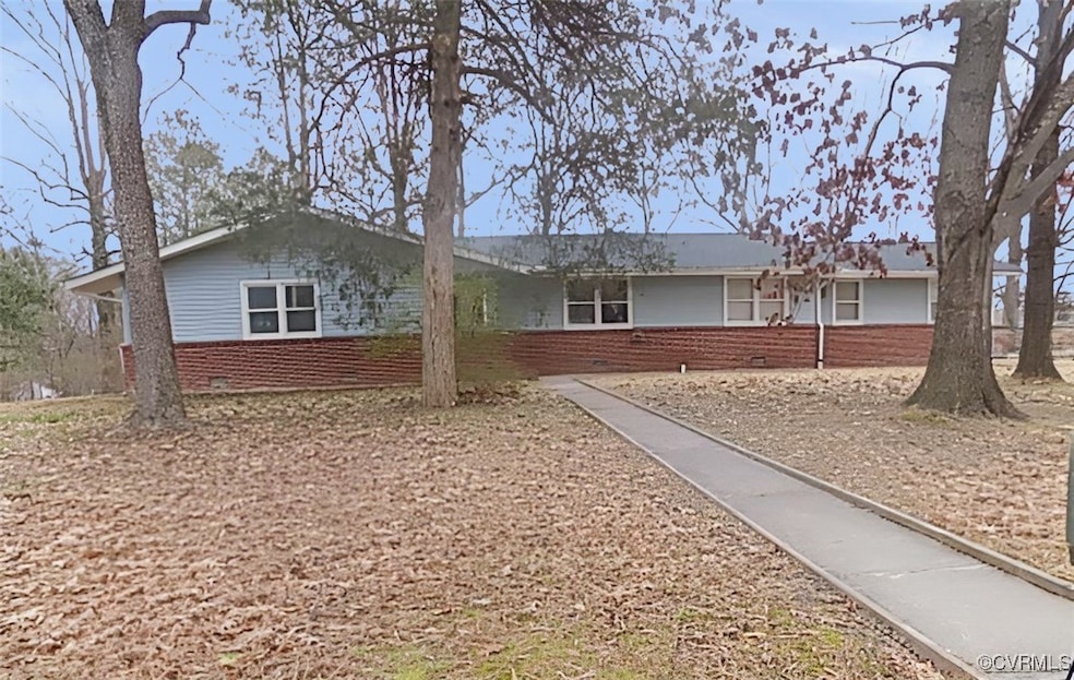 Single story home featuring brick siding