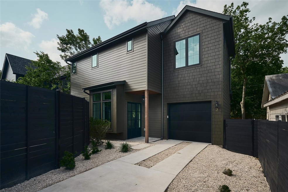 View of front facade with driveway and a garage