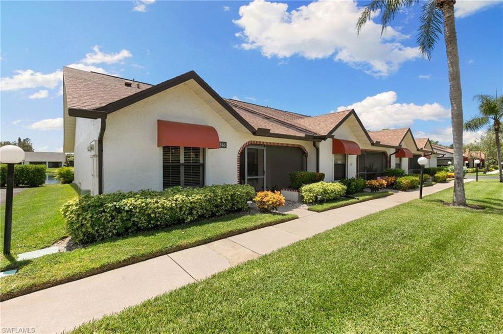 Single story home featuring a front yard, roof with shingles, and stucco siding