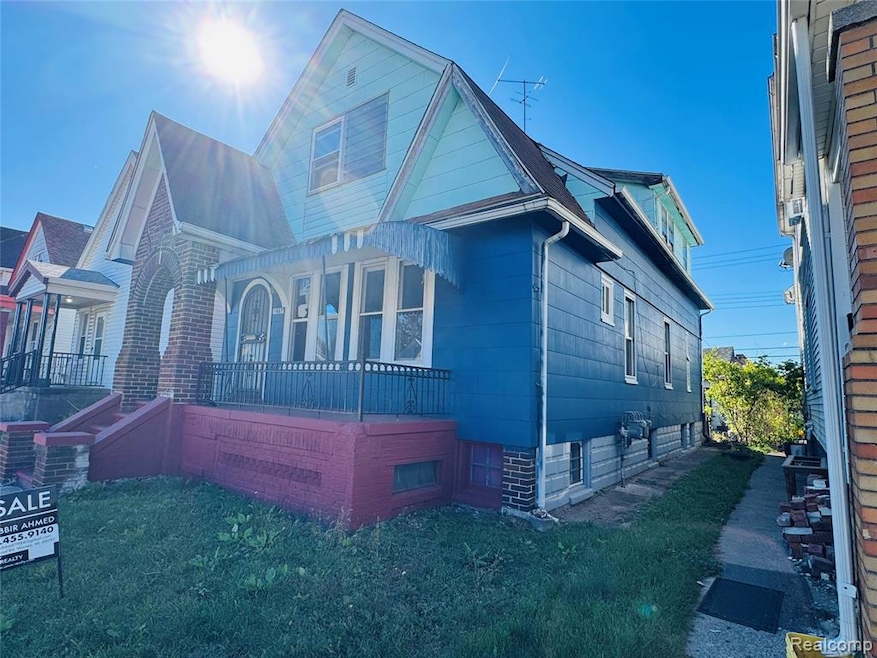 View of property exterior featuring a lawn and a porch