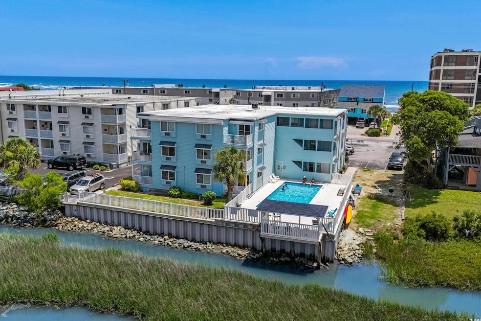 Drone / aerial view of a large body of water and a pool