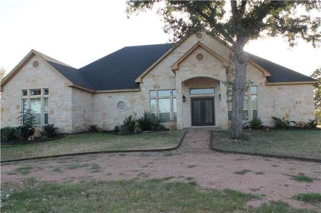front of beautiful rock home