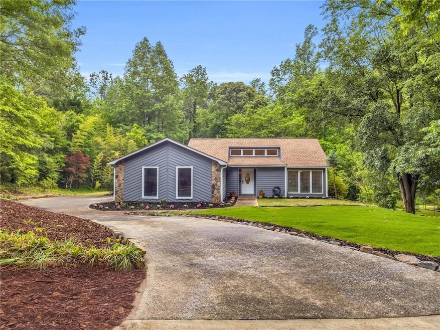 Mid-century modern home featuring driveway, a fron