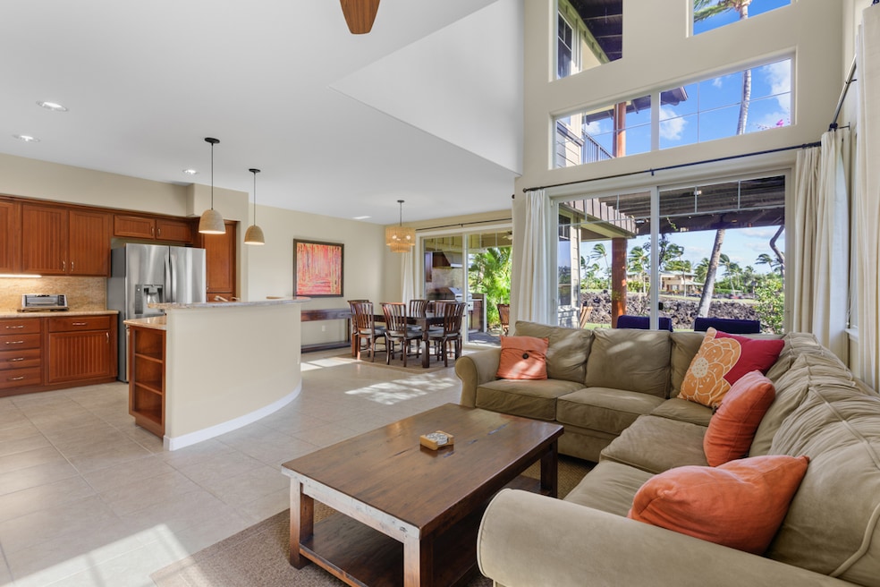 Open concept living room and kitchen with tons of natural light and high ceilings.