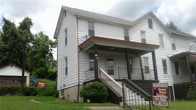 Front View of this home shows side yard and detach