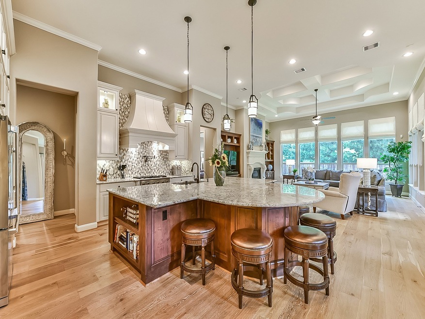 Open, flowing living areas, cook book storage on the island with maple cabinets.