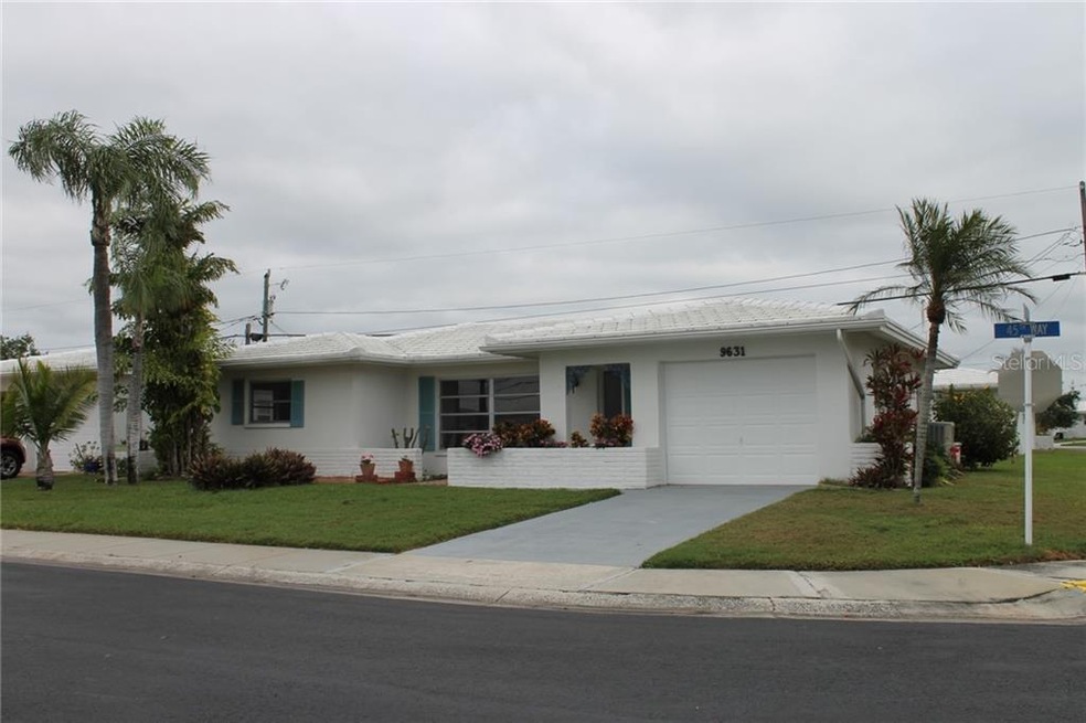 Home on a corner lot with palm trees.