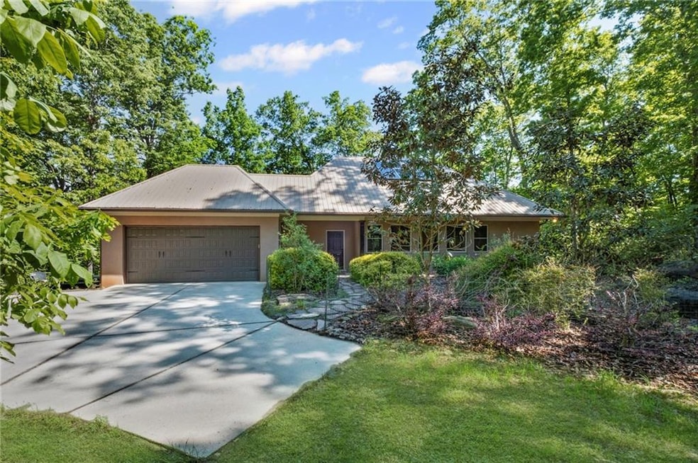 Single story home featuring driveway, and attached