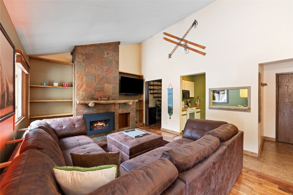 Living area with a gas fireplace, wood finished fl
