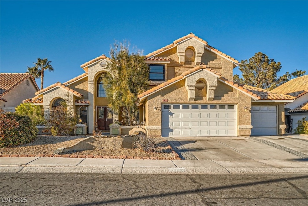 Mediterranean / spanish-style house featuring a ga
