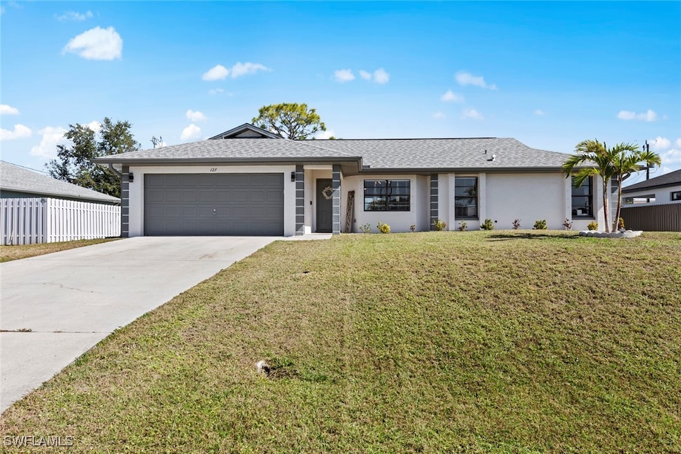 Ranch-style home with a garage and a front yard