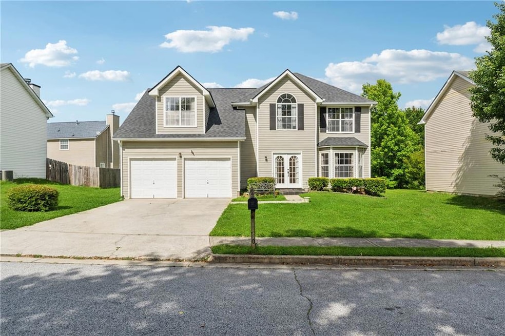 View of front of home featuring concrete driveway, french doors, a garage, and roof with shingles
