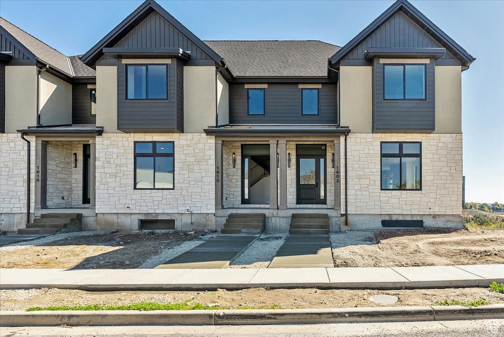 View of front facade with stone siding and board and batten siding