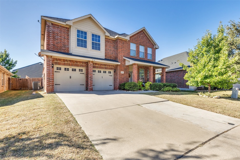 Traditional-style home with brick siding, concrete driveway, a garage, and roof with shingles