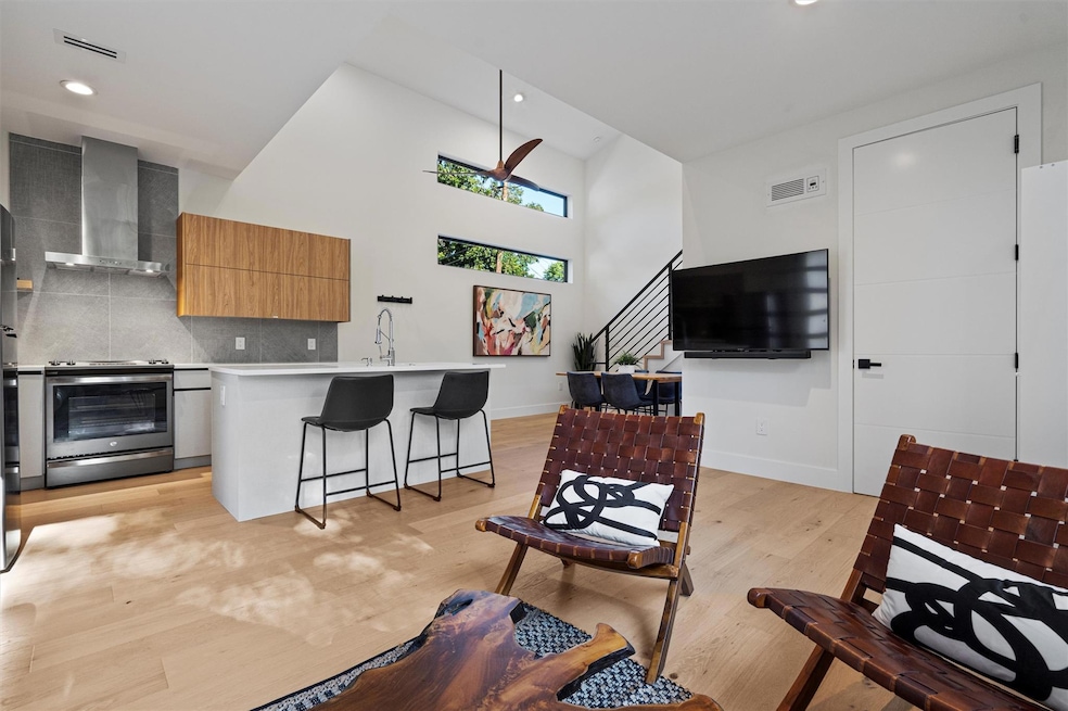 Living area with light wood-type flooring, basebo