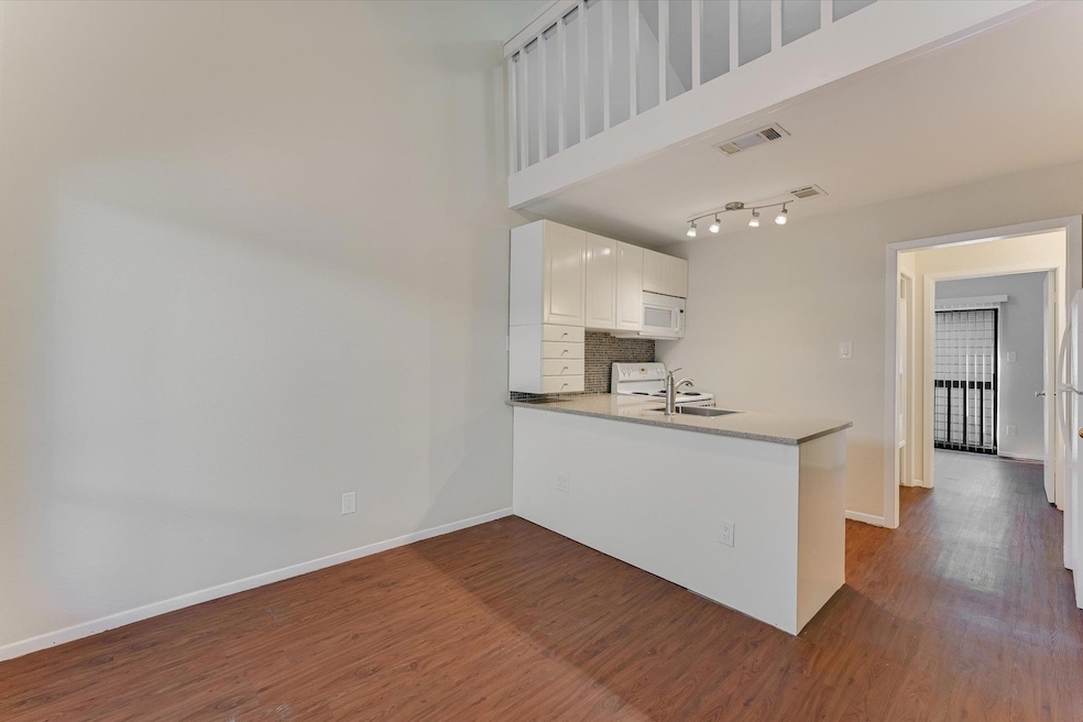 Kitchen featuring a peninsula, dark wood finished