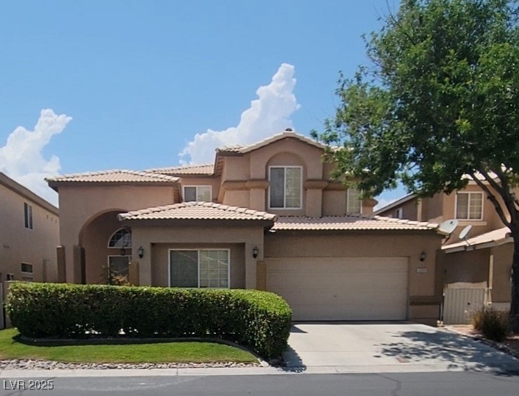 Mediterranean / spanish-style house featuring a ga