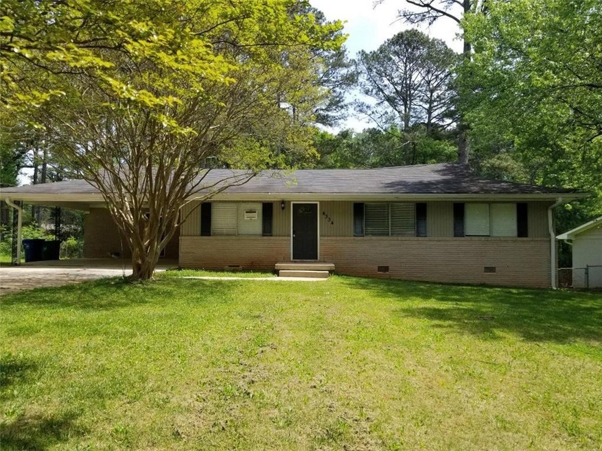 Ranch-style home featuring a carport and a front l