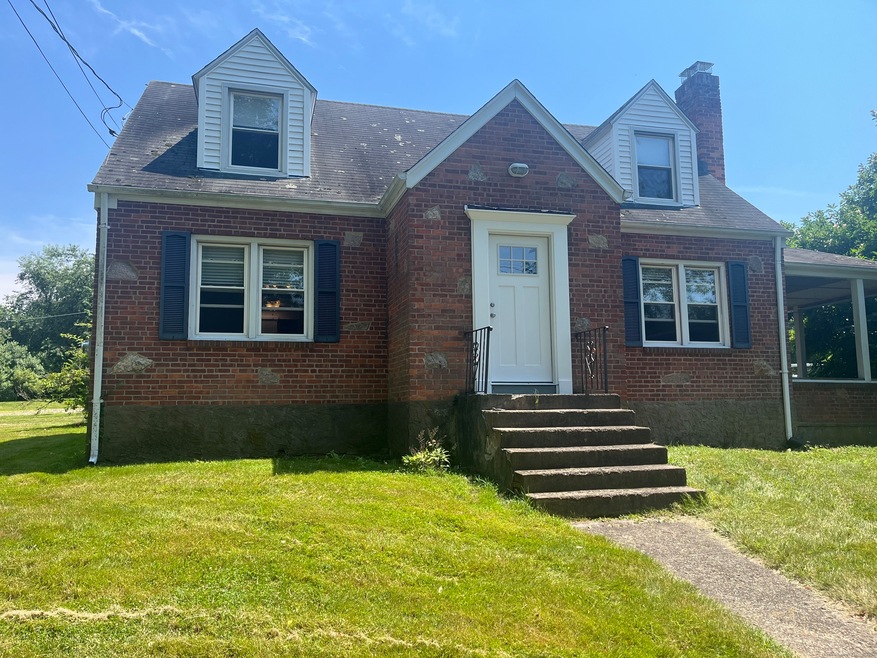 Lovely Cape Cod brick house located in a farm sett