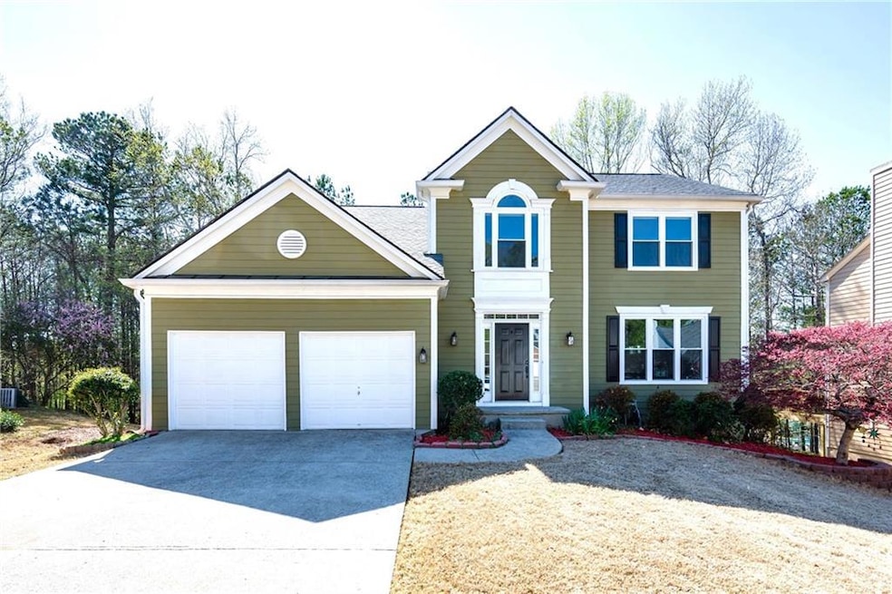 View of front of house featuring driveway and a ga
