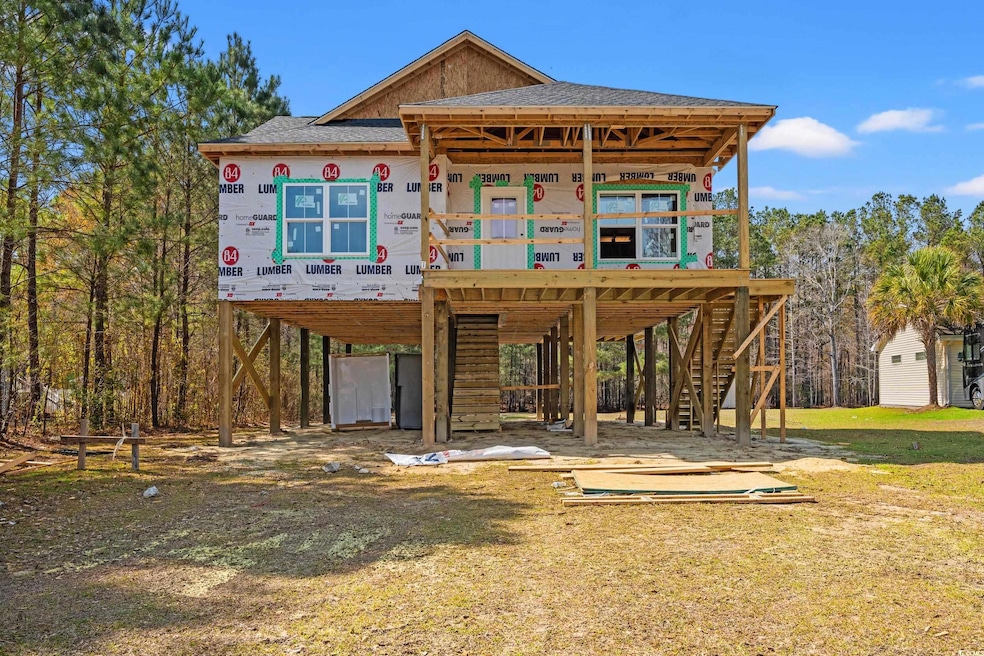 View of front of home featuring a carport, stairwa