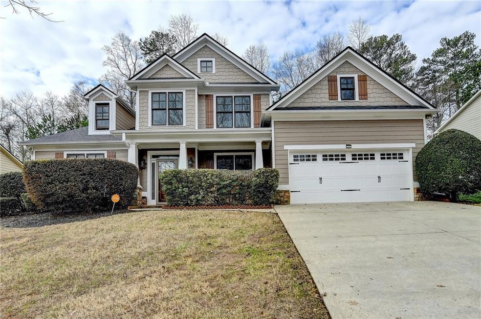 Craftsman house featuring a garage and a front yar