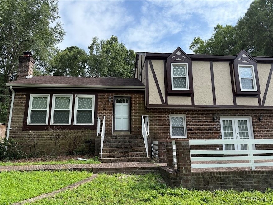 View of front of home featuring entry steps, brick