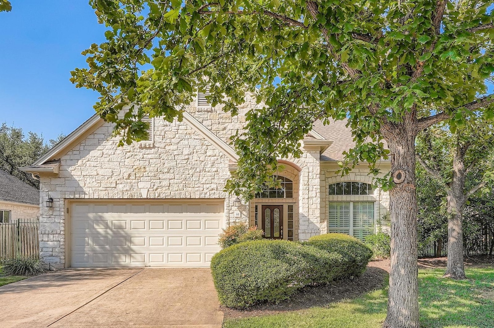 View of front of house featuring stone siding, driveway, and an attached 2 car garage w one door
