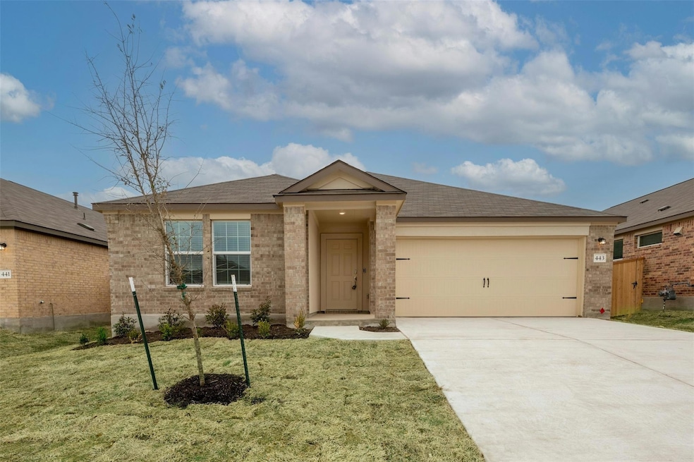 Ranch-style home featuring concrete driveway, brick siding, roof with shingles, and a garage