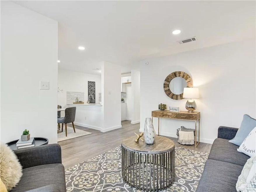 Living area with wood finished floors, baseboards